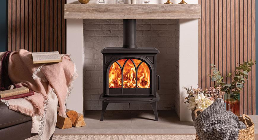 Stovax Huntingdon 30 wood burning Ecodesign stove, with Tracery Door and optional Longer Legs. Shown with ceramic wood effect beam.
