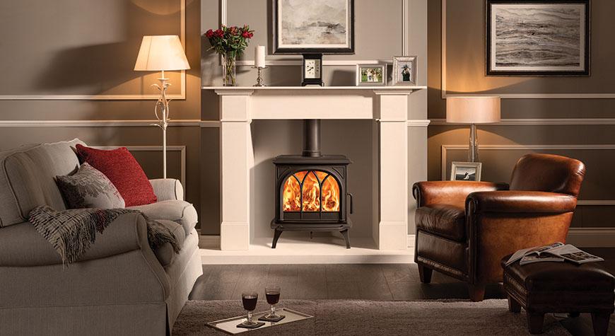 Stovax Huntingdon 30 wood burning Ecodesign stove, with Tracery Door. Shown with Claremont Limestone Mantel.