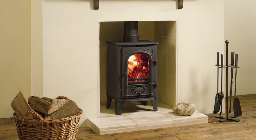 Multi-fuel version of the Stovax Stockton 4 stove  in Matt Black, burning logs.